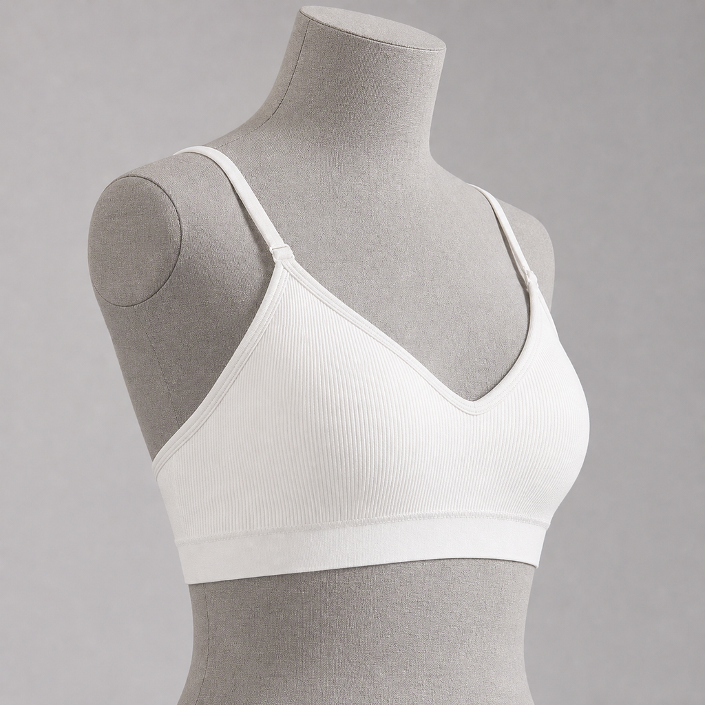 Top deportivo blanco con tirantes regulables, vista lateral.