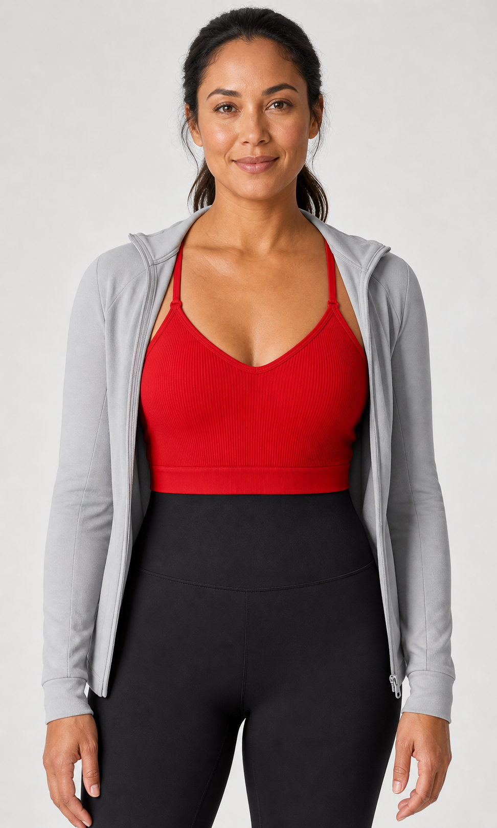Modelo adulta con top deportivo rojo acanalado y conjunto de entrenamiento.