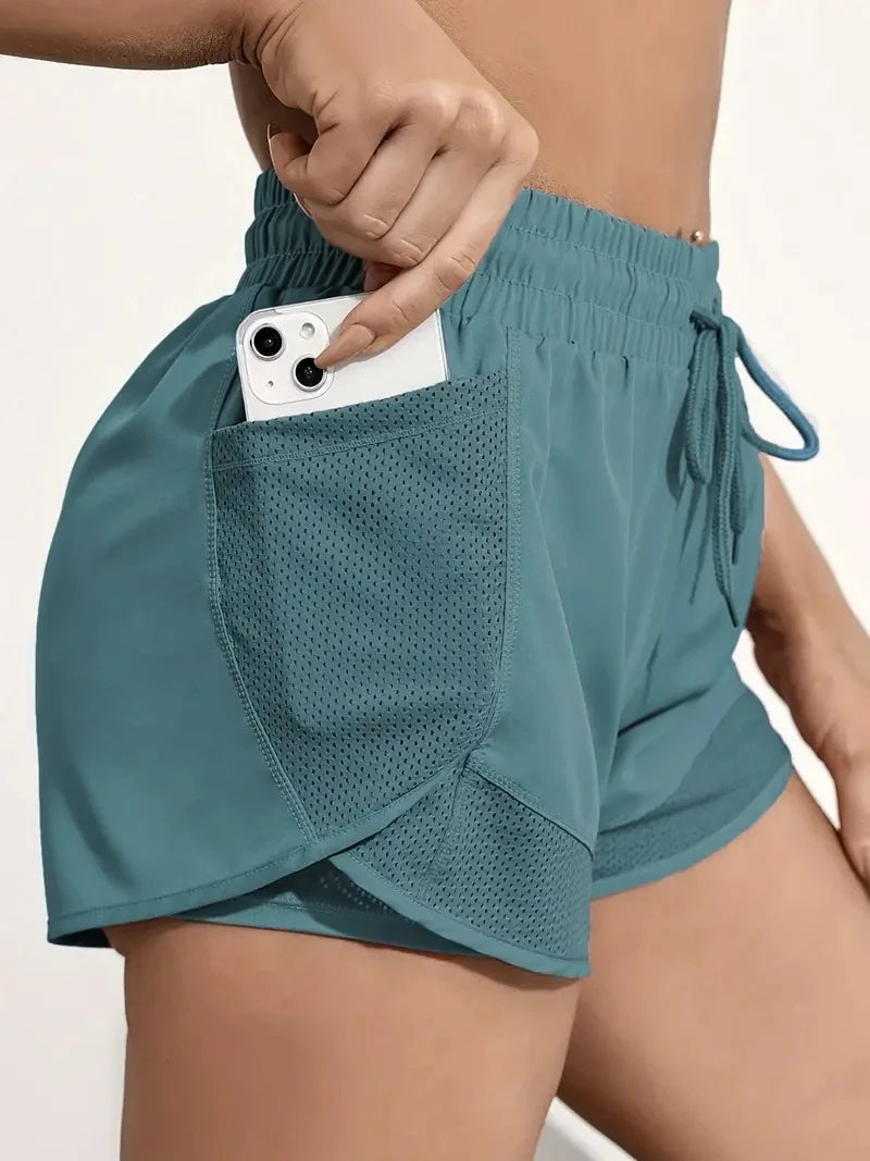Pantalón corto deportivo elástico con bolsillos para mujer, running y yoga